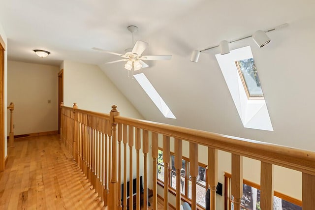 202 Wildewood Ests, Rome, ME 04963 - hallway featuring a skylight, light wood-type flooring, and vaulted ceiling
