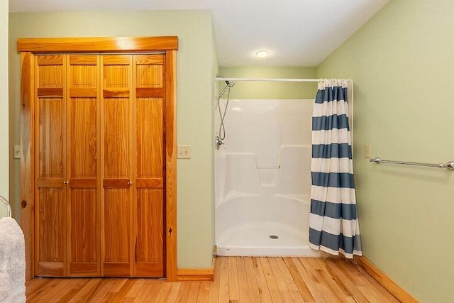 202 Wildewood Ests, Rome, ME 04963 - full bathroom featuring wood-type flooring, curtained shower, and baseboards