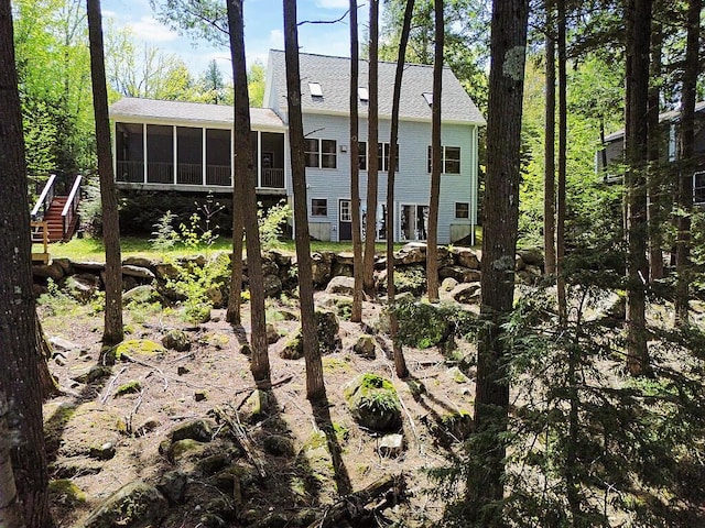 202 Wildewood Ests, Rome, ME 04963 - back of house featuring a sunroom, roof with shingles, and stairs