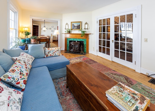 15 Federal St, Bar Harbor, ME 04609 - living area with wood finished floors, a tiled fireplace, baseboards, and french doors