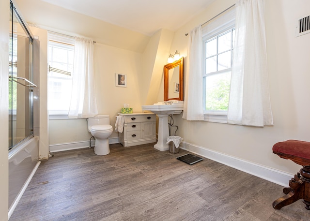15 Federal St, Bar Harbor, ME 04609 - full bath with wood finished floors, toilet, baseboards, and enclosed tub / shower combo