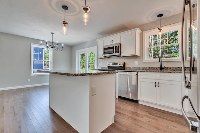 LOT10 Laney Ln, Wells, ME 04090 - kitchen with appliances with stainless steel finishes, light wood-type flooring, a kitchen island, and dark stone counters