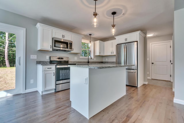 LOT10 Laney Ln, Wells, ME 04090 - kitchen with appliances with stainless steel finishes, white cabinets, baseboards, and light wood-type flooring