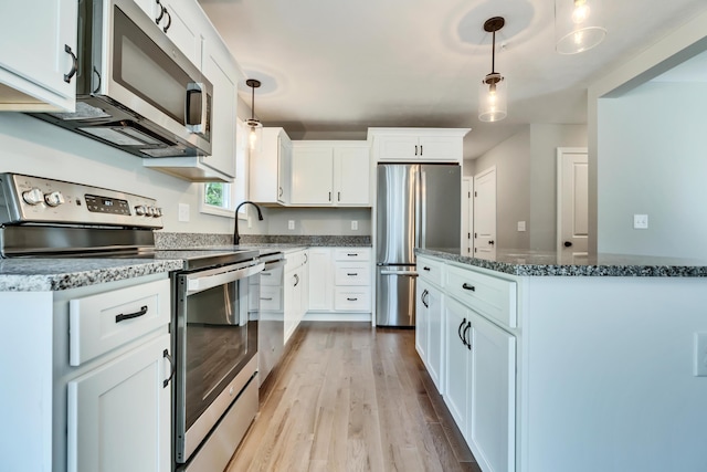 LOT10 Laney Ln, Wells, ME 04090 - kitchen featuring stainless steel appliances, light wood-type flooring, dark stone countertops, and white cabinets