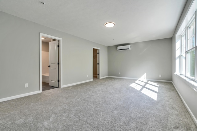 LOT10 Laney Ln, Wells, ME 04090 - unfurnished bedroom with a wall unit AC, carpet floors, a spacious closet, baseboards, and ensuite bath