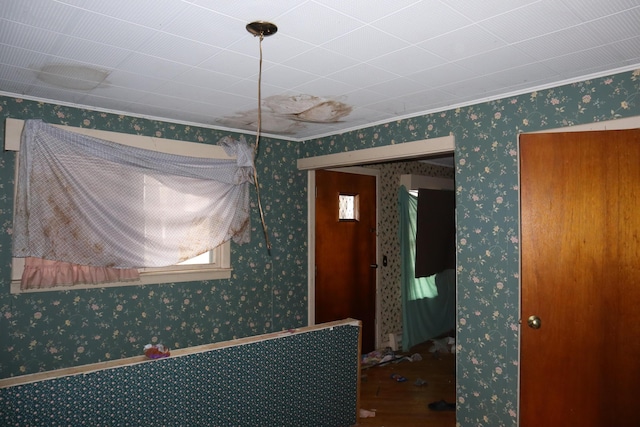17 Heselton St, Skowhegan, ME 04976 - spare room featuring crown molding, wallpapered walls, and wood finished floors