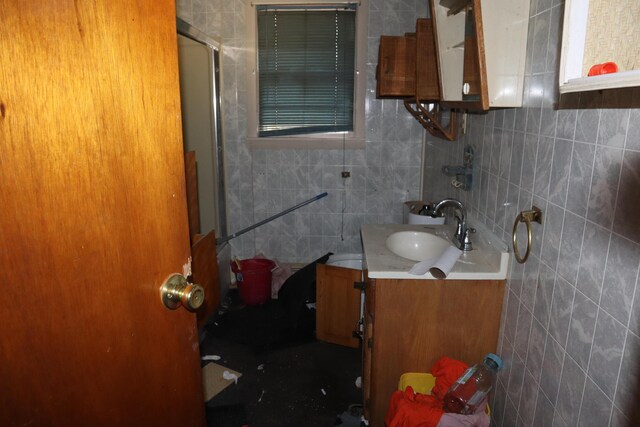 17 Heselton St, Skowhegan, ME 04976 - bathroom featuring a shower with door, vanity, tasteful backsplash, and tile walls