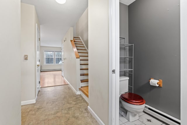 hall featuring baseboard heating, stairway, and baseboards
