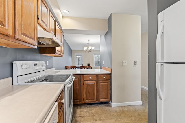 kitchen with white appliances, under cabinet range hood, a chandelier, light countertops, and baseboards