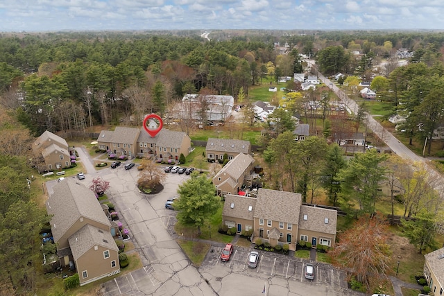 aerial overview of property's location with nearby suburban area and a forest