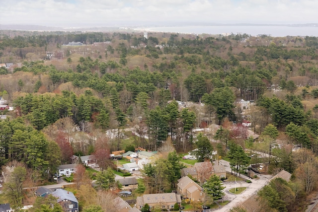 aerial view of property and surrounding area with a forest