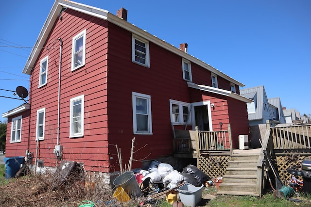 1003-1005 Main St, Vassalboro, ME 04989 - back of property featuring a chimney and a wooden deck