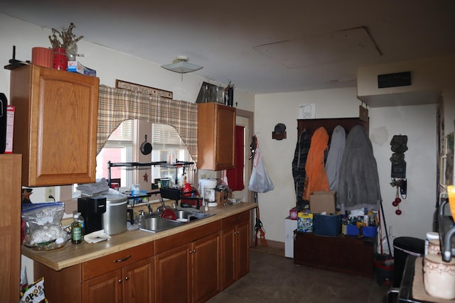1003-1005 Main St, Vassalboro, ME 04989 - kitchen with a sink, light countertops, and brown cabinetry