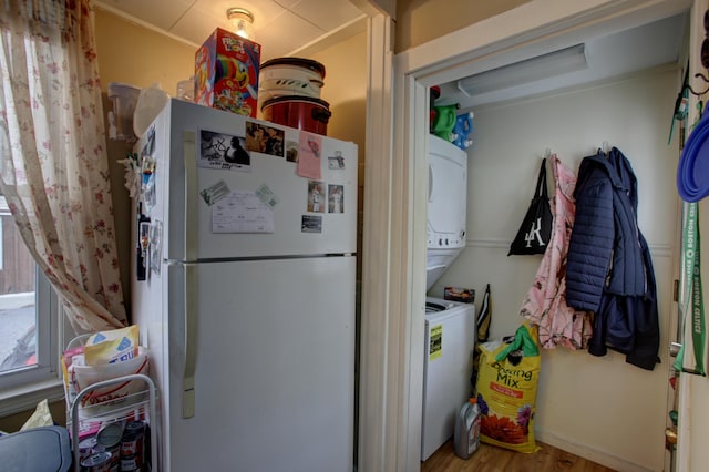 532 Main St, South Portland, ME 04106 - clothes washing area featuring stacked washer / drying machine, wood finished floors, and attic access