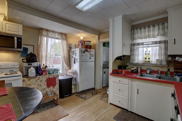 532 Main St, South Portland, ME 04106 - kitchen with white appliances, a sink, light wood-style flooring, white cabinetry, and backsplash