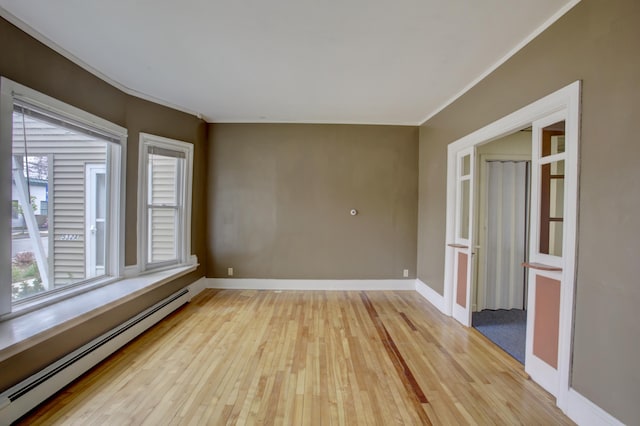 532 Main St, South Portland, ME 04106 - unfurnished room featuring a baseboard heating unit, light wood-style flooring, crown molding, and baseboards