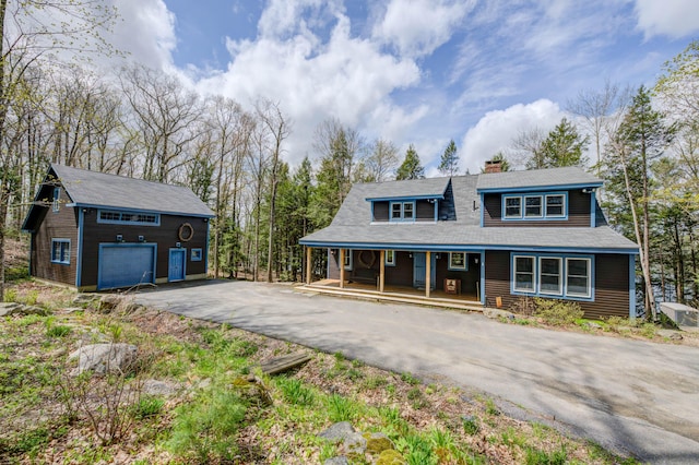 25 Winds Way Dr, Nobleboro, ME 04555 - view of front facade featuring a porch, an outbuilding, asphalt driveway, and a chimney