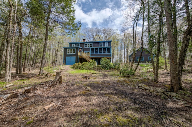 25 Winds Way Dr, Nobleboro, ME 04555 - view of front facade with stairway, a deck, and a chimney