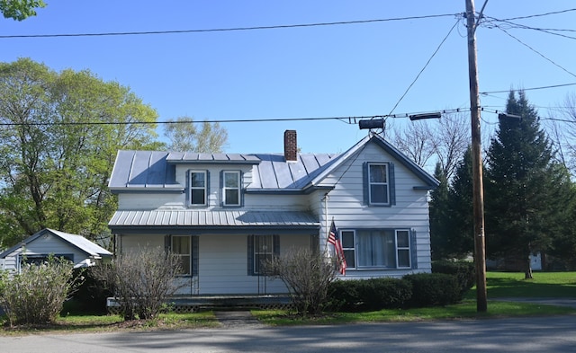 40 Baker St, Bingham, ME 04920 - view of front of house with covered porch, a standing seam roof, a chimney, and metal roof