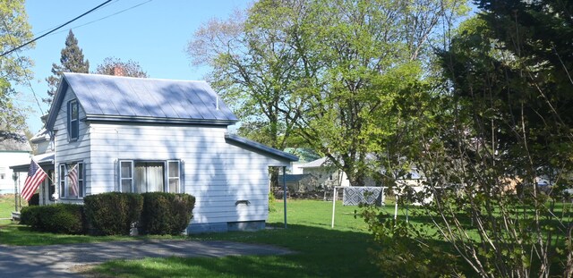 40 Baker St, Bingham, ME 04920 - view of home's exterior with a lawn and metal roof