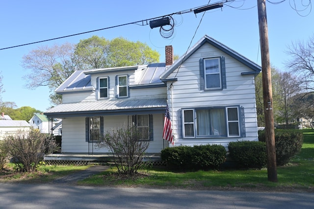 40 Baker St, Bingham, ME 04920 - view of front of home featuring a porch, a chimney, and metal roof