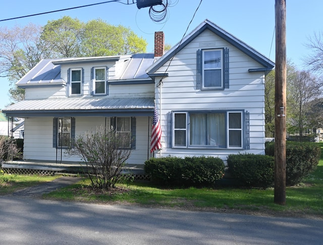 40 Baker St, Bingham, ME 04920 - view of front of home with covered porch, a chimney, and metal roof