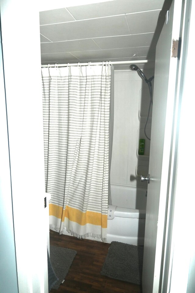 40 Baker St, Bingham, ME 04920 - full bathroom featuring wood finished floors and shower / bath combination with curtain