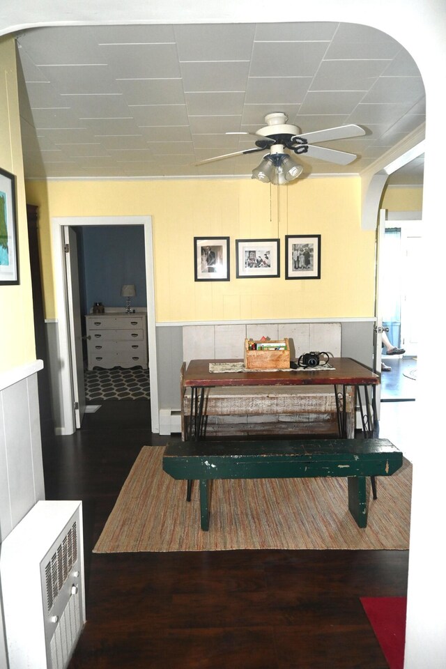 40 Baker St, Bingham, ME 04920 - dining room featuring wood finished floors, ceiling fan, arched walkways, a wainscoted wall, and baseboard heating