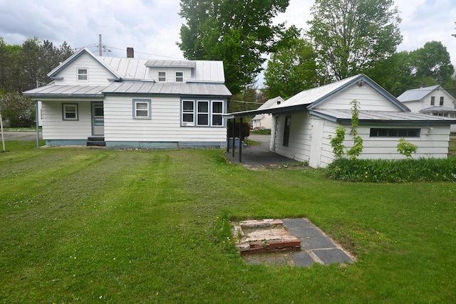 40 Baker St, Bingham, ME 04920 - rear view of house featuring a yard, a standing seam roof, and metal roof