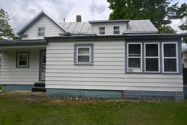 40 Baker St, Bingham, ME 04920 - view of home's exterior with a standing seam roof, metal roof, and a lawn