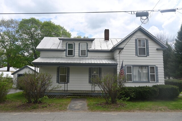 40 Baker St, Bingham, ME 04920 - view of front facade featuring a porch, a chimney, and metal roof