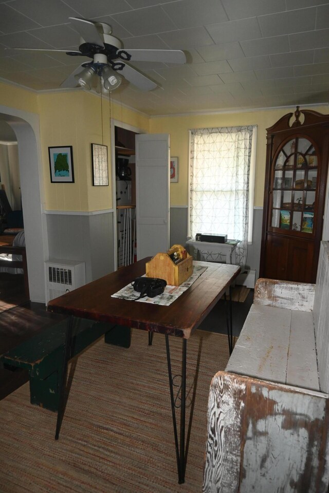 40 Baker St, Bingham, ME 04920 - dining area featuring a wainscoted wall, a ceiling fan, arched walkways, radiator heating unit, and carpet floors