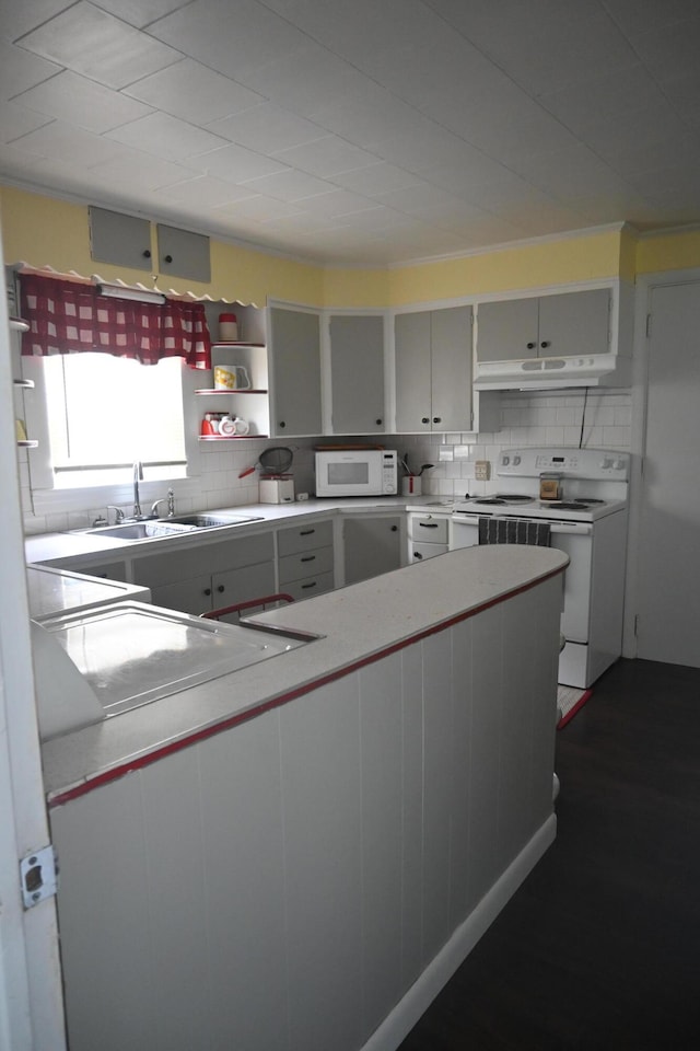 40 Baker St, Bingham, ME 04920 - kitchen with white appliances, under cabinet range hood, open shelves, and decorative backsplash