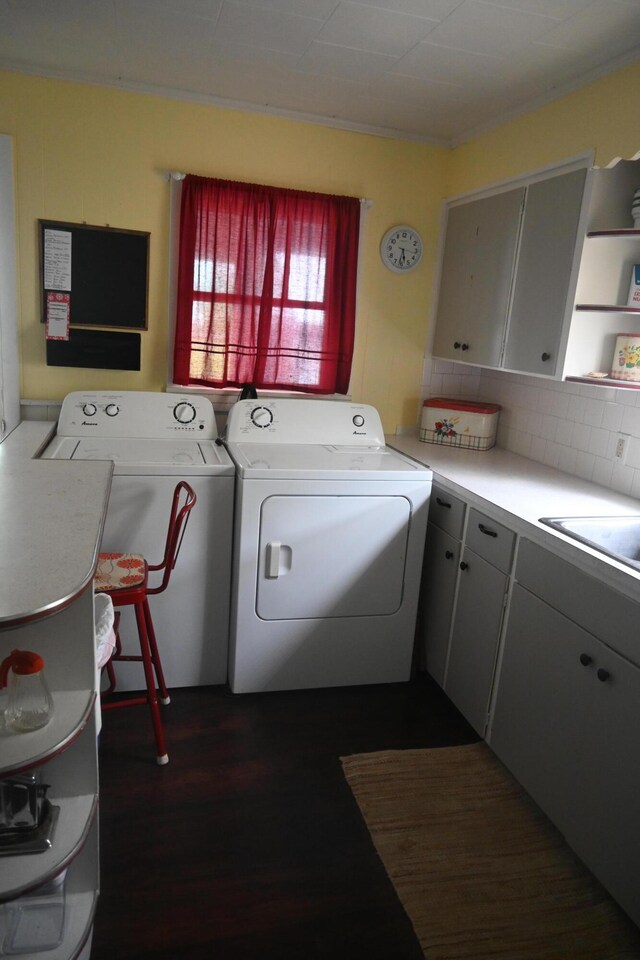 40 Baker St, Bingham, ME 04920 - washroom with separate washer and dryer, cabinet space, dark wood-style floors, and crown molding
