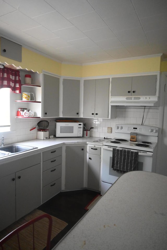 40 Baker St, Bingham, ME 04920 - kitchen with white appliances, under cabinet range hood, light countertops, decorative backsplash, and open shelves