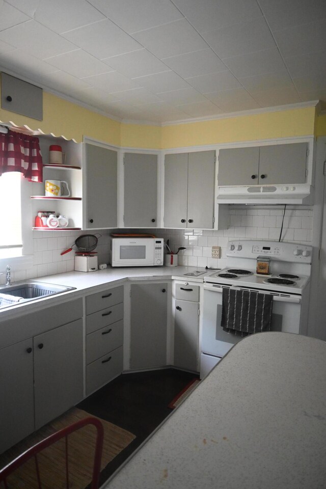 40 Baker St, Bingham, ME 04920 - kitchen with white appliances, under cabinet range hood, open shelves, light countertops, and backsplash