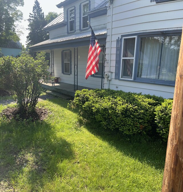 40 Baker St, Bingham, ME 04920 - view of home's exterior featuring a porch and a yard