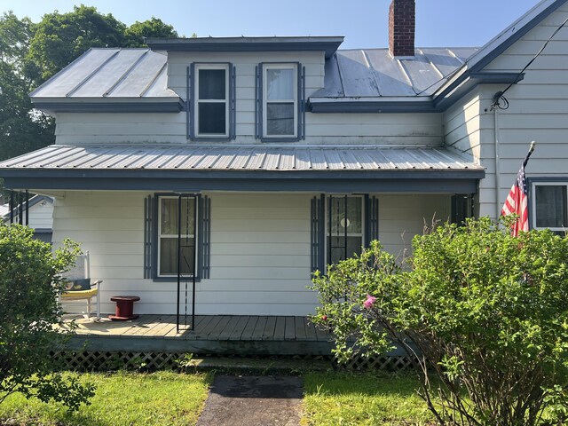 40 Baker St, Bingham, ME 04920 - view of property exterior with a porch, a chimney, and metal roof
