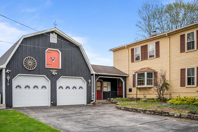 691 N Rd, Parsonsfield, ME 04047 - view of front facade with asphalt driveway, a gambrel roof, an attached garage, and a chimney