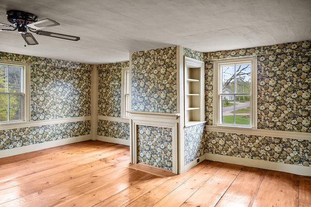 691 N Rd, Parsonsfield, ME 04047 - spare room featuring light wood-style floors, a ceiling fan, baseboards, and wallpapered walls