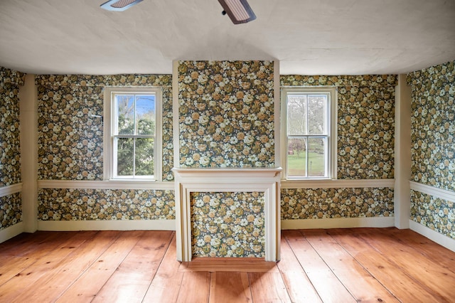 691 N Rd, Parsonsfield, ME 04047 - unfurnished room with a ceiling fan, hardwood / wood-style flooring, baseboards, and wallpapered walls