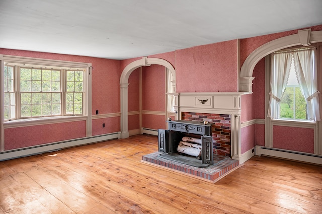 691 N Rd, Parsonsfield, ME 04047 - living area with arched walkways, baseboard heating, and hardwood / wood-style flooring