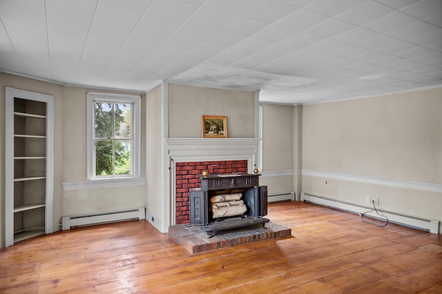691 N Rd, Parsonsfield, ME 04047 - unfurnished living room with a baseboard heating unit, a baseboard radiator, hardwood / wood-style floors, a wood stove, and crown molding