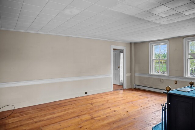 691 N Rd, Parsonsfield, ME 04047 - bedroom featuring a baseboard heating unit, light wood-style floors, and ornamental molding