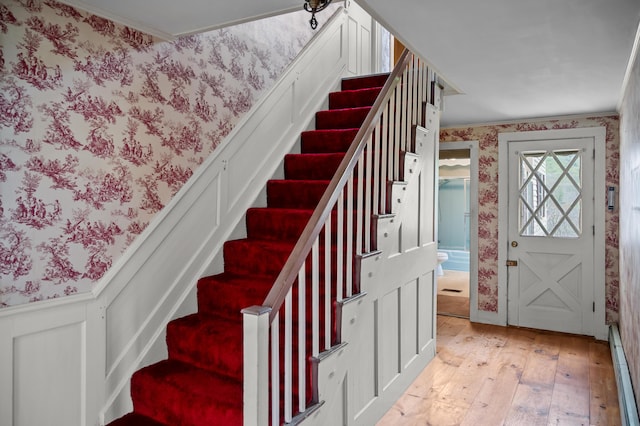 691 N Rd, Parsonsfield, ME 04047 - stairway featuring wallpapered walls, wood-type flooring, crown molding, and a wainscoted wall