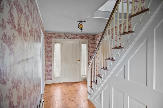 691 N Rd, Parsonsfield, ME 04047 - foyer with wallpapered walls, light wood-style floors, stairway, a baseboard heating unit, and baseboards