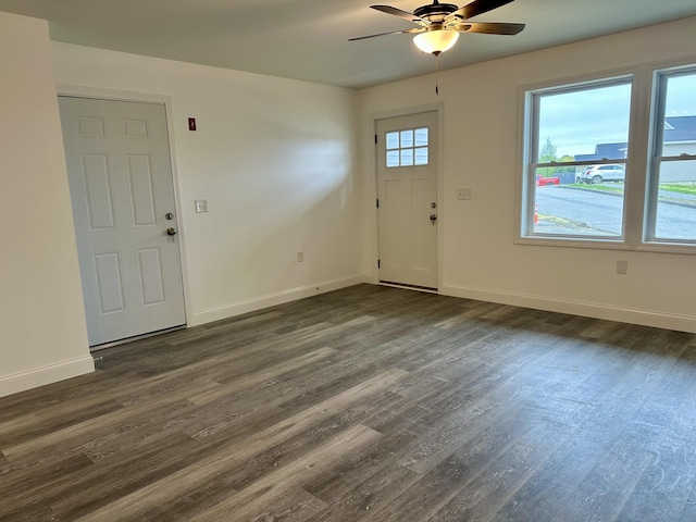 entrance foyer with ceiling fan, dark wood-type flooring, and baseboards