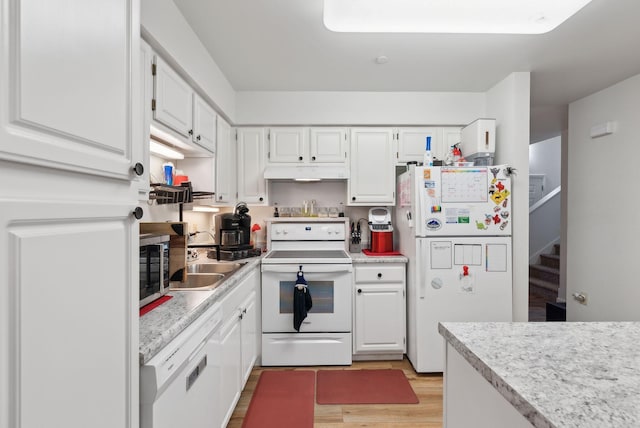 10 Hornet St Unit 10, Brunswick, ME 04011 - kitchen with white appliances, light wood-type flooring, under cabinet range hood, a sink, and light countertops