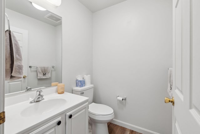 10 Hornet St Unit 10, Brunswick, ME 04011 - half bathroom featuring wood finished floors, toilet, vanity, and baseboards