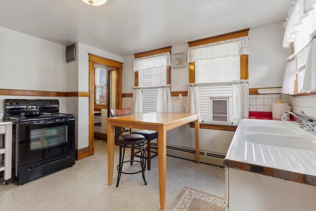 kitchen with black range with electric stovetop, baseboard heating, a sink, and light countertops